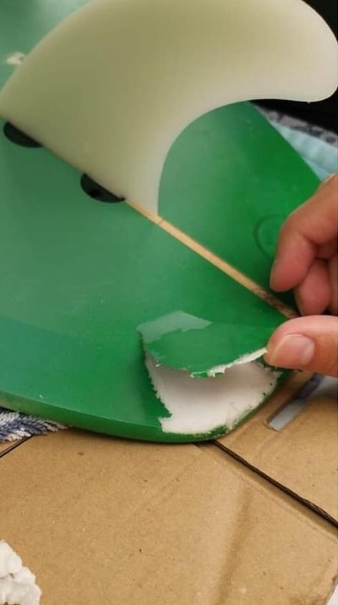Green surfboard needs delamination repaired on the tail as well as a colour match